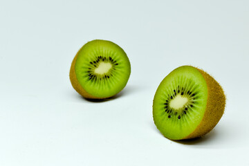 Two half of kiwi on light background