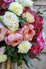 Wedding floral decoration with roses, peonies, hortensias, carnations and other flowers.