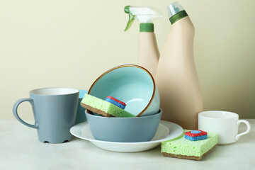 Concept of Dishwashing detergent accessories on white textured table