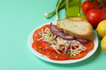 Concept of tasty food with tomato carpaccio on mint background
