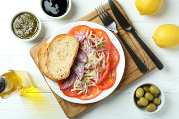 Concept of tasty food with tomato carpaccio on white wooden table