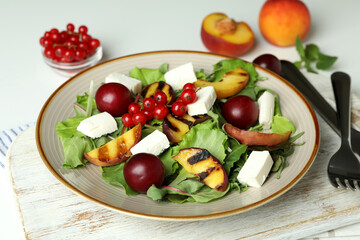 Concept of tasty salad with grilled peach, close up