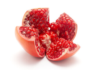 Close-up of  organic red pomegranate in section cut of four pieces  (Punica granatum) isolated over...