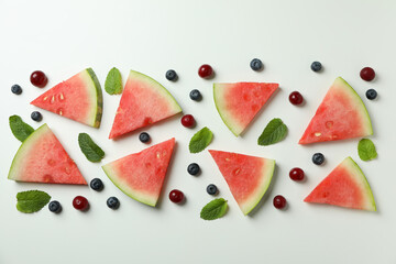 Flat lay with watermelon slices and berries on white background
