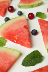 Flat lay with watermelon slices and berries on white background