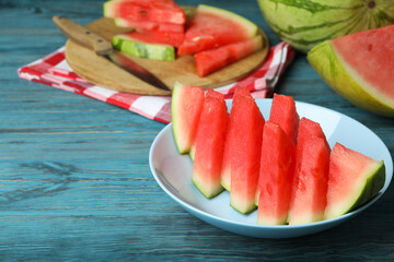 Concept of tasty food with watermelon on blue wooden table
