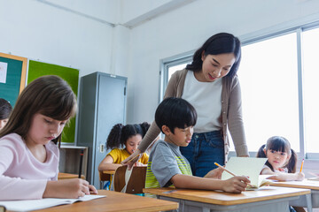 Diversity elementary school kid Take note Teacher lecture in classroom
