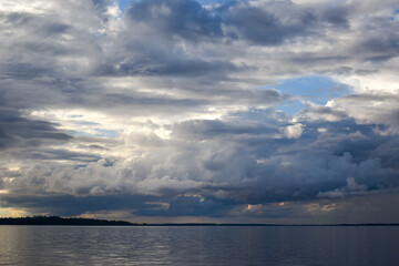 Dark evening clouds over river