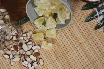 Sliced Almonds and Dried Pineapple on Bamboo Mat Close up
