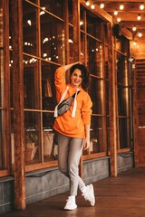 happy bright girl walks against the backdrop of glowing lanterns.