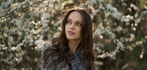 pretty brunette woman in the spring park