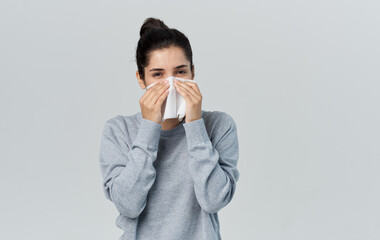 woman wiping her nose with a handkerchief flu health problems treatment