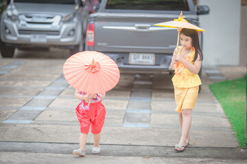 Close-up background view of a blurred Asian girl running or teasing in the street in front of the...