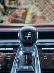Cockpit interior details cabin of modern sport car, Close-up automatic gear shift Transmission and electronic handbrake controls.