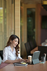 Portrait and side view with businesswoman working on tablet in the meeting room.