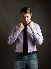 Portrait of angry young man on dark background.