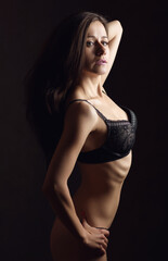Sensual adult woman in black underwear. Studio shot.