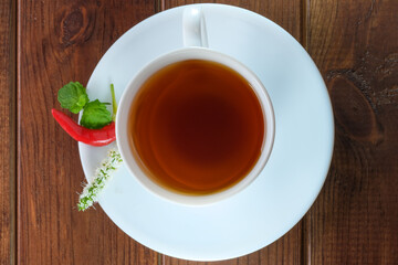 White faience cup with black tea