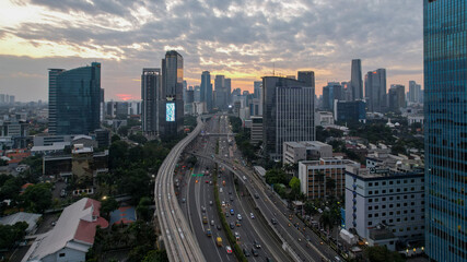Fototapeta premium Aerial view of Panoramic photo of Jakarta overlooking Parklands, and the city skyline with a spectacular sunset. Jakarta, Indonesia, August 13, 2021