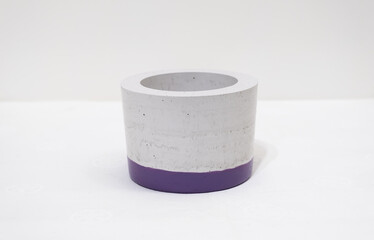 Colorful, handmade cactus pot on a white background with fine holes in the texture and painted bottom