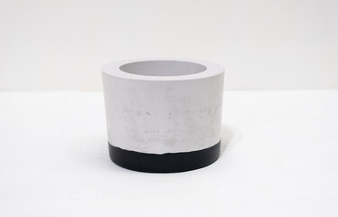 Colorful, handmade cactus pot on a white background with fine holes in the texture and painted bottom