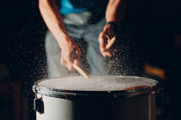 Close up drum sticks drumming hit beat rhythm on drum surface with splash water drops - obrazy, fototapety, plakaty