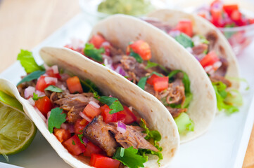 Tacos with pulled pork, tomato salsa and guacamole 