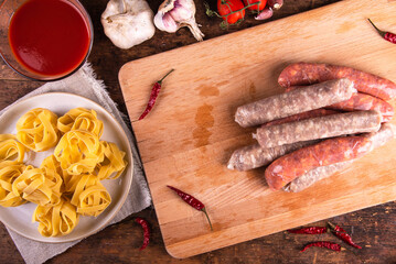 Cooking American pasta with sausage stew, Pasta with Sausage Ragu.  ingredients on the table - two...