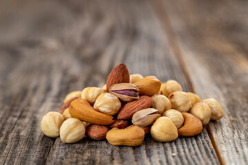 Mixed nuts on wood floor. Organic and fresh nuts. close up