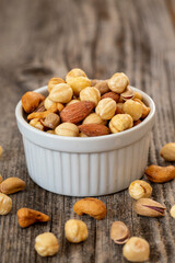 Mixed nuts in a ceramic plate. Organic and fresh nuts. close up