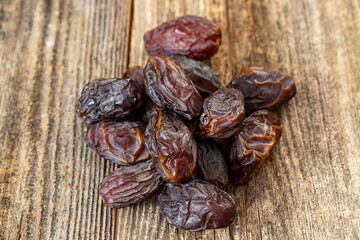 Date fruit on wood background. Organic and fresh nuts. close up