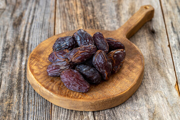 Date fruit on wood background. Organic and fresh nuts. close up