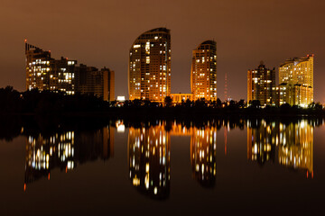 night city with reflection of houses in the river