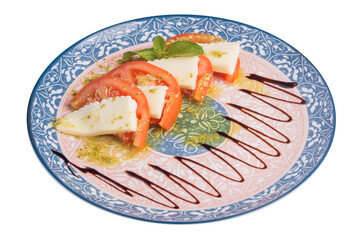 Tomatoes with cheese and mint on a plate