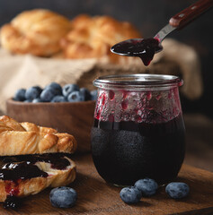Jar and spoon of blueberry Jam