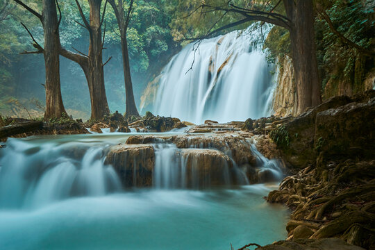 Scenic view of the waterfall through rocks in the rainforest