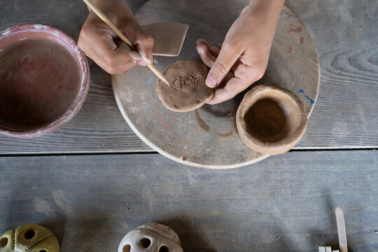 boy working with clay in pottery workshop