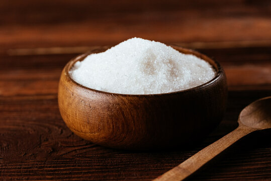 white sugar in a wooden bowl