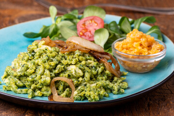 bavarian spinach spaetzle on a blue plate