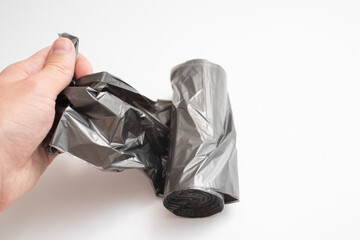 Roll of plastic garbage bags in hand