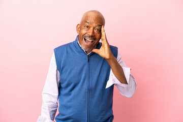 Cuban senior isolated on pink background shouting with mouth wide open