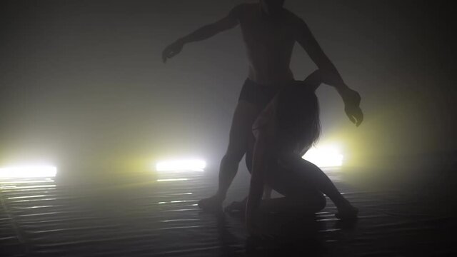 Modern dance couple dancers in studio with special lighting effects