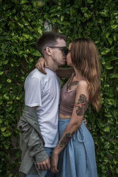 Portrait of millennial couple in love kissing. stylish picture. Wearing casual clothes. High quality photo 