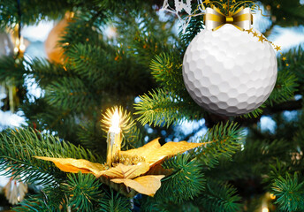 Golf christmas bauble hanging on the fir branch. Christmas greeting