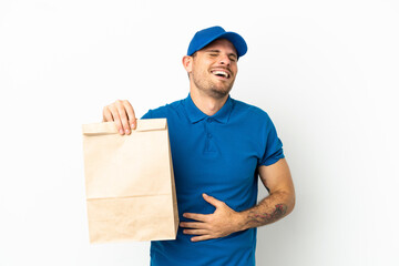 Brazilian taking a bag of takeaway food isolated on white background smiling a lot