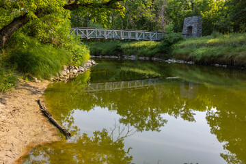 Swing Bridge Over A River In The Woods