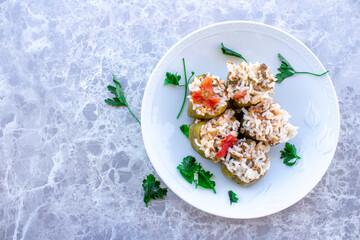 Top view of stuffed peppers in a plate.