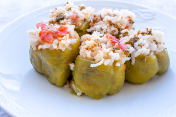 Close-up photo of stuffed peppers in white plate.