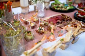 Food catering appetizers snacks on a tray on table.