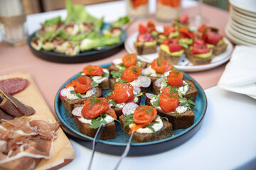 Food catering appetizers snacks on a tray on table.
